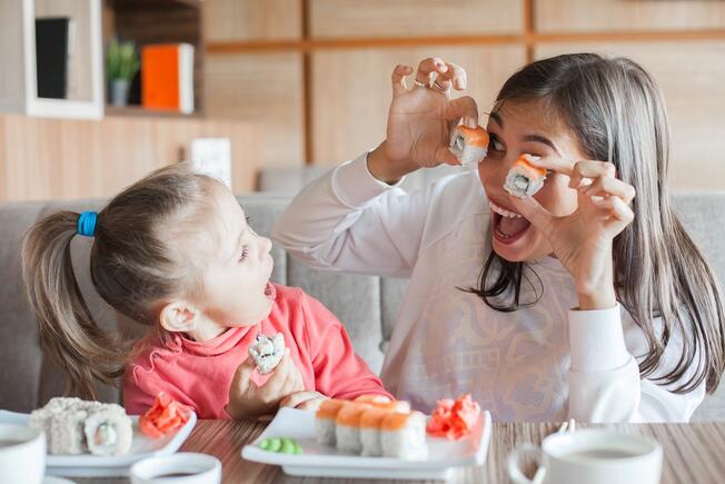Mum with daughter eating and smiling